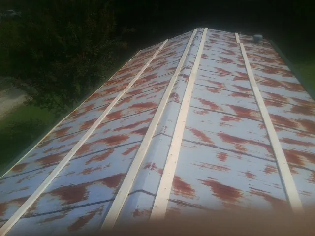 Rusted metal roof panels with new wood purlins before replacement — Storm Damage Roof Repair in Scotch Plains by Roofing Brothers