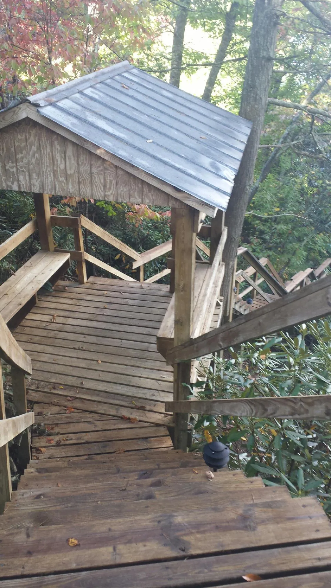 Metal roofed shelter over wooden steps on a wooded walkway — Skylight Repair & Installation work by our crew in Scotch Plains