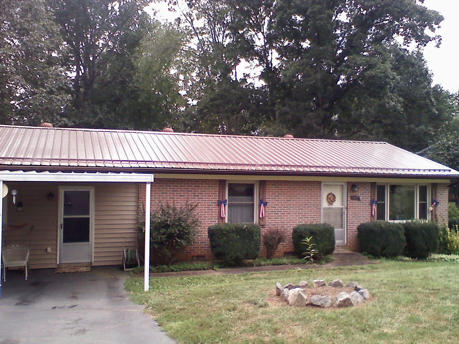 Bronze metal roof and carport on a brick ranch home — Roof Repair work by our crew in Scotch Plains