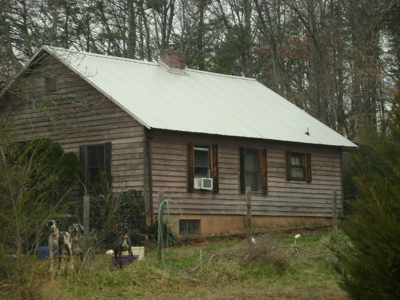 White metal roof on an old wood sided farmhouse, from a Metal Roof Installation job in Scotch Plains